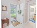 A welcoming foyer with neutral walls, light-colored tile flooring, and a view into the bathroom at 4541 Southfield Ave, Orlando, FL 32812