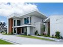 Stunning two-story home with modern architecture, lush landscaping, and a paved driveway at 5023 Sawyer Cove Way, Windermere, FL 34786