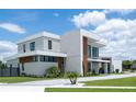 Contemporary two-story home features a modern design, manicured lawn, and beautiful landscaping at 5023 Sawyer Cove Way, Windermere, FL 34786