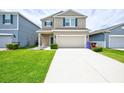 Beautiful two-story home with a spacious driveway, well-kept lawn, and inviting curb appeal at 5164 Chickadee St, St Cloud, FL 34771