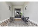 Inviting front porch with decorative tile, charming seating, and stylish decor at 5427 Orange Orchard Dr, Winter Garden, FL 34787