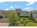 Inviting home exterior with a lush, landscaped front yard and a paver driveway at 553 Adenmore Ter, Deland, FL 32724