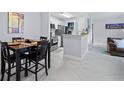 Modern kitchen with stainless steel appliances, granite countertops, and a cozy dining area at 6100 Westgate Dr # 101, Orlando, FL 32835