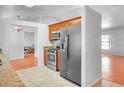 Features modern stainless steel appliances and spacious tile flooring adjoining breakfast nook at 618 Meadow Park Dr, Minneola, FL 34715