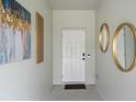 Stylish foyer featuring modern decor, including decorative mirrors, creating an elegant and welcoming entry at 6340 Chorus Dr, Mascotte, FL 34753