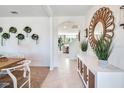 Open entryway with decorative mirror, console table, and a view of the dining and living areas at 7059 Painted Bunting Way, St Cloud, FL 34773