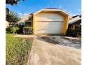 Lovely single-Gathering home featuring a spacious driveway and garage, framed by mature trees and verdant landscaping at 7228 Spring Villas Cir, Orlando, FL 32819