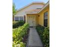 Welcoming front entrance with landscaped pathway, and a charming front door at 7228 Spring Villas Cir, Orlando, FL 32819