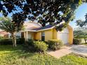 Inviting single-Gathering home with a well-manicured lawn, complemented by mature shade trees and lush greenery at 7228 Spring Villas Cir, Orlando, FL 32819