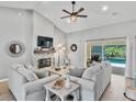 Bright living room with a fireplace, cozy furniture and sliding glass doors to a screened lanai at 1024 Destin Dr, Lake Wales, FL 33898