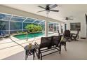 Enclosed screened lanai featuring comfortable outdoor seating overlooking a private pool at 1024 Destin Dr, Lake Wales, FL 33898