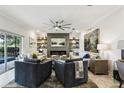 Stylish living room featuring modern furnishings, a sleek fireplace, custom built-in shelving, and contemporary décor at 1082 Trappers Trail Loop, Davenport, FL 33896