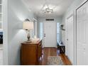 Inviting entryway features hardwood floors, decorative lighting, and a classic wooden console table at 1133 Brandy Lake View Cir, Winter Garden, FL 34787