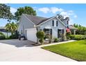 Corner lot featuring home exterior with a two-car garage and a well-manicured lawn at 1133 Brandy Lake View Cir, Winter Garden, FL 34787