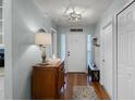 Welcoming foyer with wood floors, fresh paint, and decorative lighting at 1133 Brandy Lake View Cir, Winter Garden, FL 34787