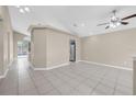 Bright living room with vaulted ceilings, ceiling fan, neutral paint, and tile flooring throughout at 12832 Downstream Cir, Orlando, FL 32828