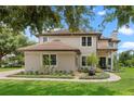 Charming two-story home with well-manicured landscaping and brick walkway leading to the front entrance at 13120 Zori Ln, Windermere, FL 34786