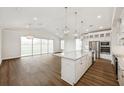 Open-concept kitchen and living area with a large island, stainless steel appliances, and plenty of natural light at 13123 Faro Ct # 23, Winter Garden, FL 34787