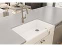 Close-up of a farmhouse-style kitchen sink with a modern faucet and countertops at 13123 Faro Ct # 23, Winter Garden, FL 34787