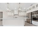 Bright, open kitchen featuring white cabinets, stainless steel appliances, and a large center island at 13187 Telsen St # 38, Winter Garden, FL 34787
