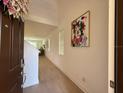 Bright foyer features a wood floor, high ceilings and an art piece at 14533 Crestavista Ave, Clermont, FL 34714