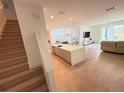 Open concept living area boasts wood floors, large windows and a modern kitchen at 14533 Crestavista Ave, Clermont, FL 34714