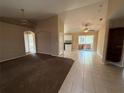 Open-concept living space with living room, dining area, tile flooring, and neutral paint at 1931 N Portillo Dr, Deltona, FL 32738