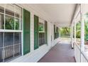 Inviting front porch of a charming home featuring green shutters and ample natural light at 2320 Red Ember Rd, Oviedo, FL 32765