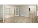 Spacious living room with tile floors and French doors leading to the backyard at 2320 Red Ember Rd, Oviedo, FL 32765