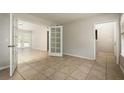 Spacious living room featuring tile floors, neutral paint and french doors leading to the backyard at 2320 Red Ember Rd, Oviedo, FL 32765