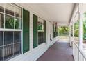 View of the front porch featuring green shutters and a view of the surrounding yard and foliage at 2320 Red Ember Rd, Oviedo, FL 32765