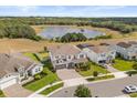 Aerial view of a house with pond and wooded views in a suburban neighborhood at 2431 Knoll Dr, Apopka, FL 32712