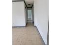 Neutral hallway featuring tile flooring that leads to other areas of the home at 3463 Fekany Pl, Orlando, FL 32805