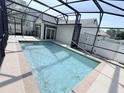 Screened in pool with deck and partial house view at 402 Ravenshill Way, Deland, FL 32724