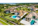 Expansive backyard featuring a private pool, lush landscaping, and an outdoor entertainment area, perfect for relaxation at 4065 Isabella Cir, Windermere, FL 34786