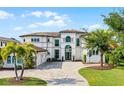 Elegant home showcasing a beautifully designed facade, manicured lawn, and a welcoming driveway entrance at 4065 Isabella Cir, Windermere, FL 34786