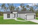 Attractive single-story home with black trim, and a manicured front lawn at 4364 Sw 172Nd Street Rd, Ocala, FL 34473