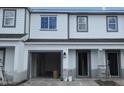 Exterior view of townhome featuring a one-car garage and covered entry at 5113 Prairie Preserve Run, St Cloud, FL 34772