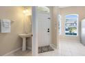 Bright entryway featuring a pedestal sink, tile flooring, and natural light at 600 Northern Way # 1807, Winter Springs, FL 32708