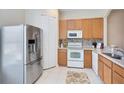 Modern kitchen with stainless steel refrigerator and white appliances at 600 Northern Way # 1807, Winter Springs, FL 32708