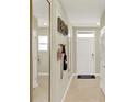 Light-filled hallway features neutral walls, tile flooring, and decorative wall accents at 797 Ambleside Dr, Haines City, FL 33844