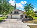 Charming two-story home featuring a three-car garage and beautiful palm trees at 80 White Marsh Cir, Orlando, FL 32824