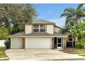 Charming two-story home featuring a three-car garage, well-manicured landscaping, and a welcoming front entrance at 80 White Marsh Cir, Orlando, FL 32824