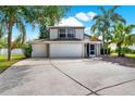 Charming two-story home featuring a three-car garage and lush landscaping at 80 White Marsh Cir, Orlando, FL 32824