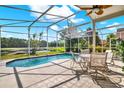 Inviting screened-in pool with a picturesque view of the water and lush landscaping at 80 White Marsh Cir, Orlando, FL 32824