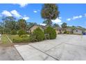 An exterior view of the property featuring a concrete driveway and desert landscaping in the front at 820 Hobson St, Longwood, FL 32750