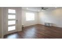 Bright living room with modern ceiling fan and beautiful laminate wood flooring at 8563 Compass Point Ave, Orlando, FL 32832