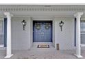 Stylish double front door with decorative wreaths and elegant pillars at the home's entrance at 105 Spring Cove Trl, Altamonte Springs, FL 32714