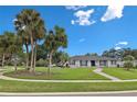 Charming single-story home with a well-manicured lawn, mature palm trees, and inviting curb appeal at 105 Spring Cove Trl, Altamonte Springs, FL 32714