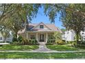 Beautiful single-Gathering home showcasing lush landscaping, brick walkway and inviting front porch at 11415 N Camden Commons Dr, Windermere, FL 34786